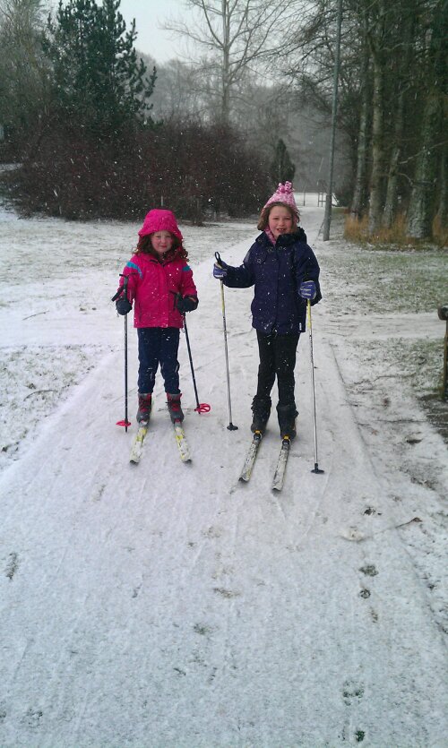 image of two girls skiing